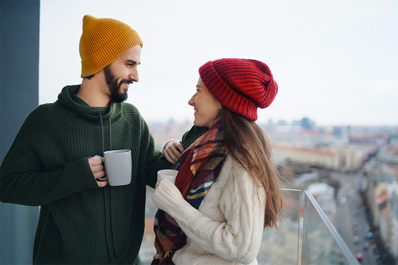 A Couple Drinks Tea On A Balcony In Winter