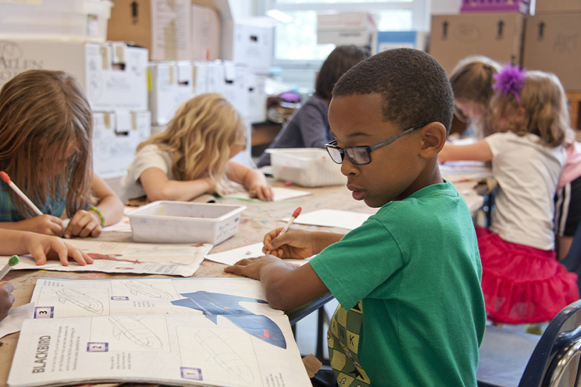 A Kid In School Writing Down