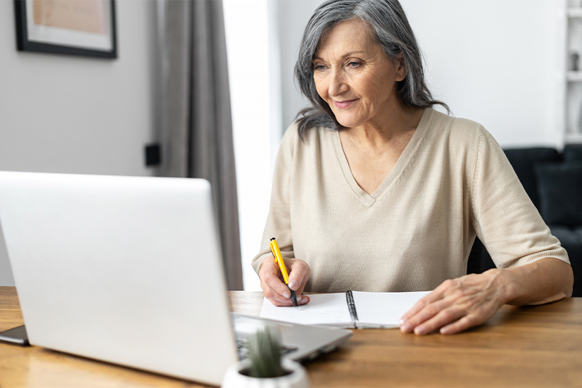 A Senior Woman Researches Online On Movers