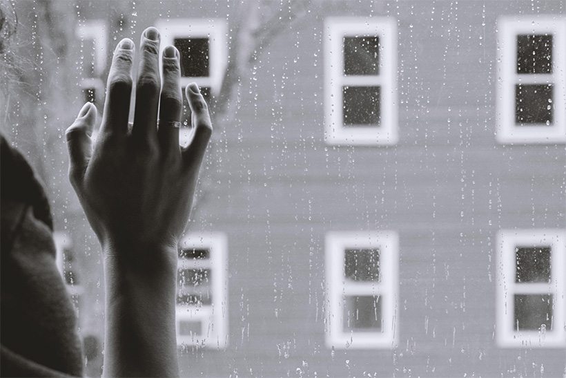 A Woman's Hand On A Window On A Rainy Day