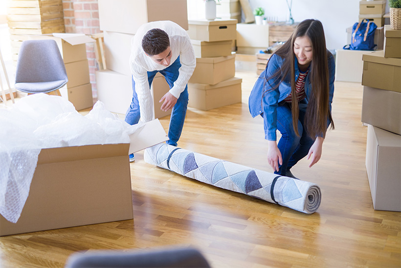 A guy and a girl are packing things for moving