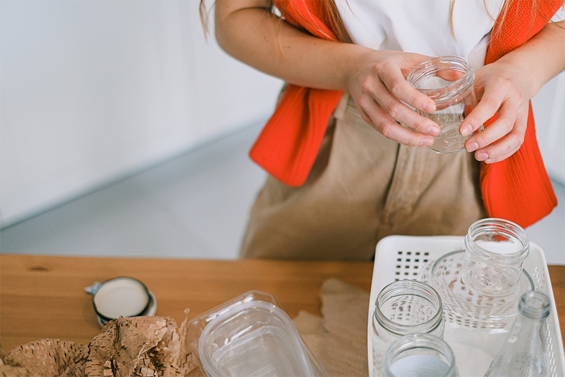 A Woman Packs Glass Jars