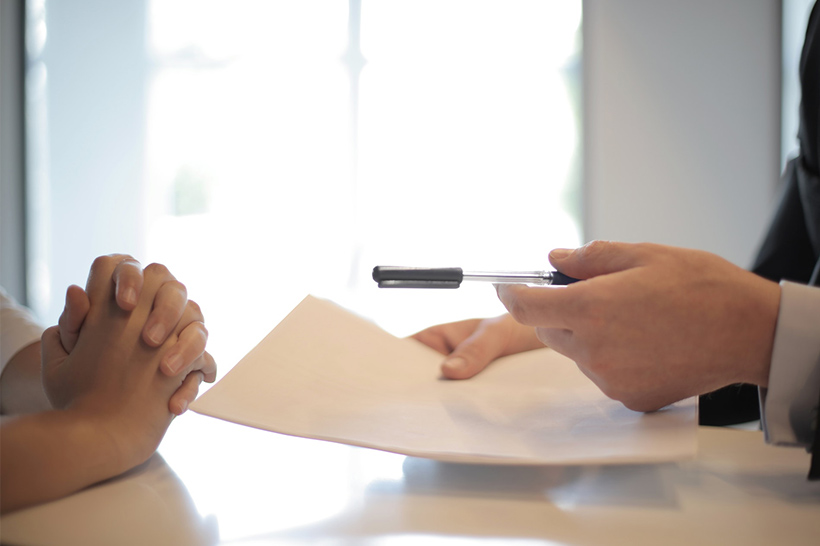 A Woman Is Signing Insurance Papers