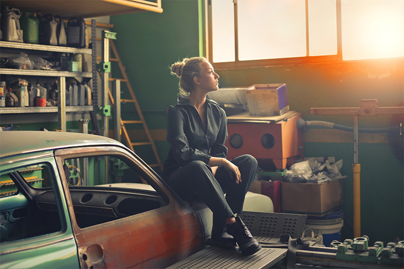 A woman sitting in a neat garage