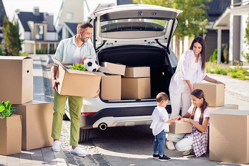 A Family is Packing Things In A Car For Moving