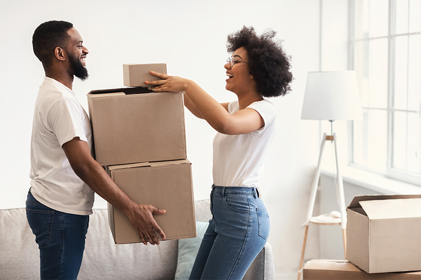 A Couple is Packing Items In Cardboard Boxes