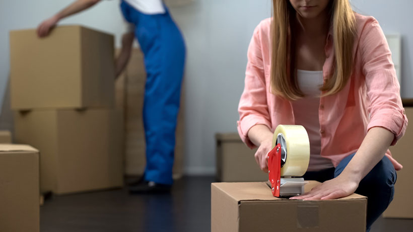 A Woman Sealing the Box for Moving