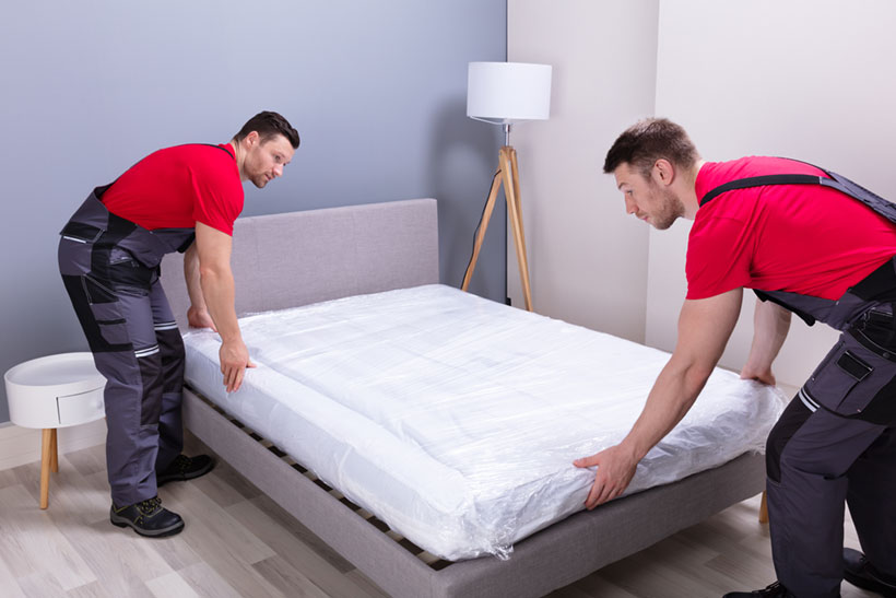 Two Movers Moving A King Size Mattress